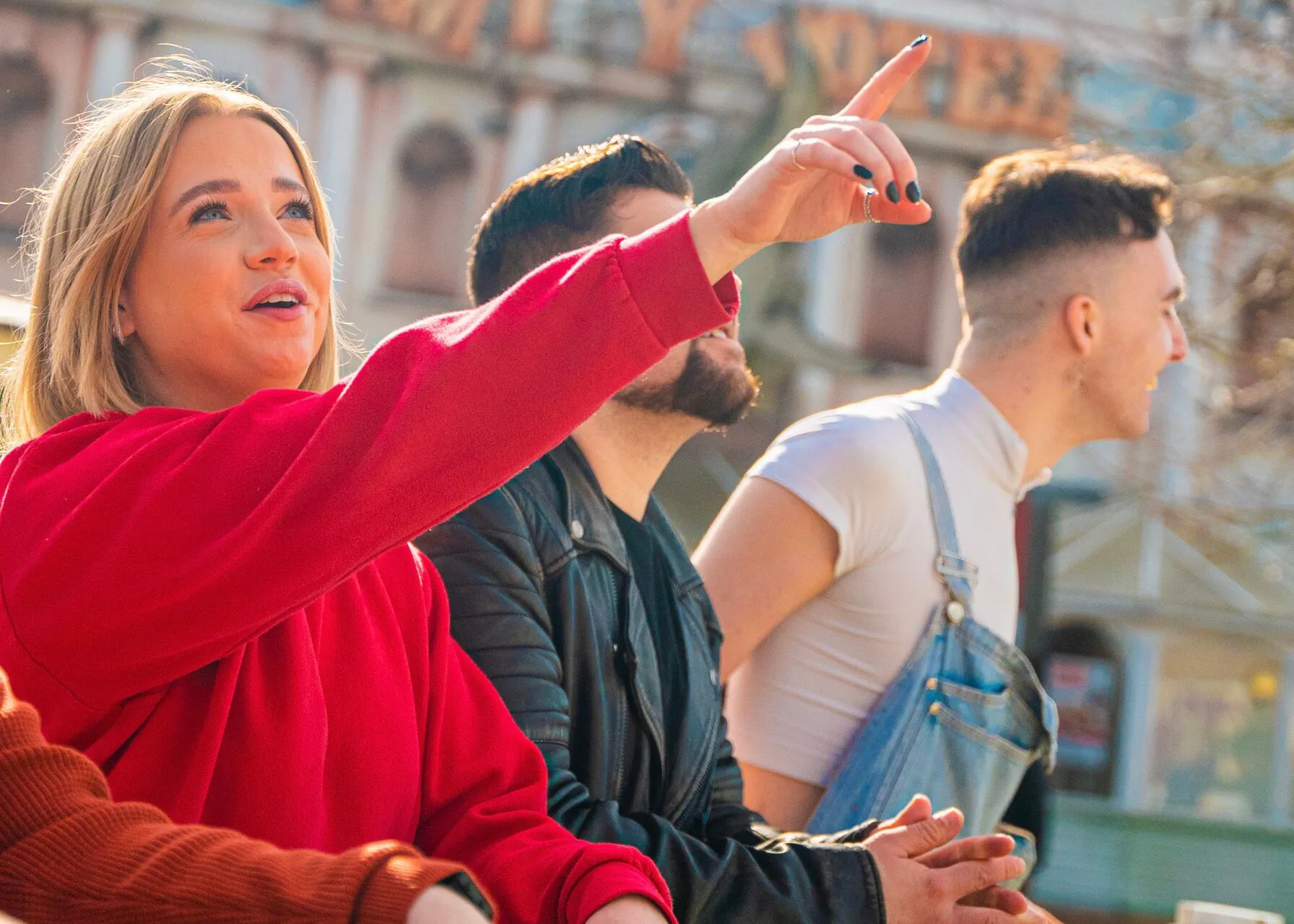 Group of people and woman pointing up at Thorpe Park