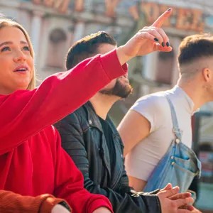 Group of people and woman pointing up at Thorpe Park