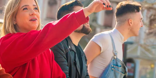 Group of people and woman pointing up at Thorpe Park