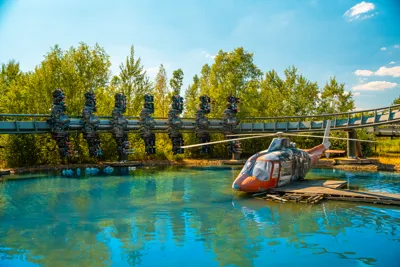 Wide shot of guests on The Swarm going past the helicopter