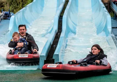 Kip Hakes and his family coming down the depth charge water slides