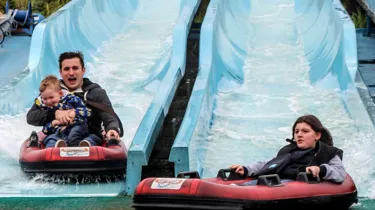 Kip Hakes and his family coming down the depth charge water slides