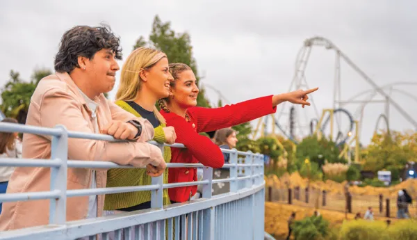 3 guests stood on a balcony looking over towards the Thorpe Park