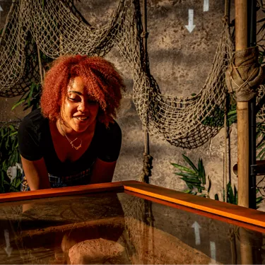 Jungle Escape Puzzle Escape Room, guest solving table puzzle