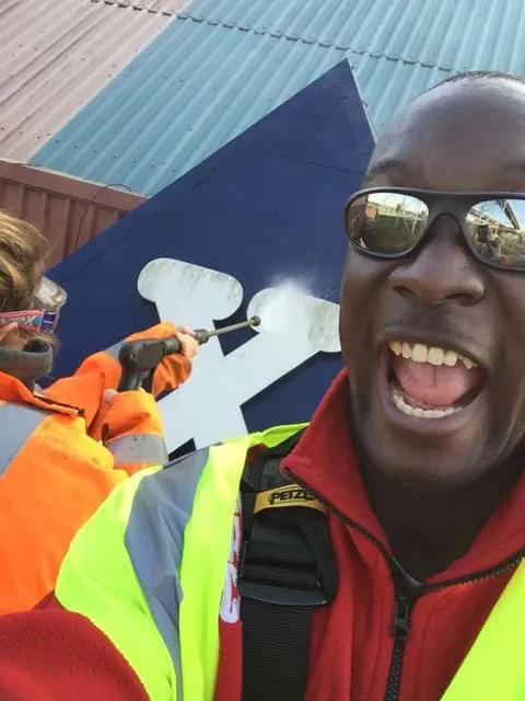 Employees taking a selfie whilst cleaning the entrance to the X rollercoaster