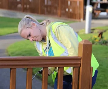 Employee repainting a bench