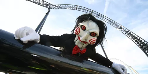 Billy doll from SAW laying on SAW rollercoaster track
