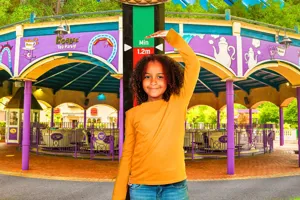 Girl measuring her height with her hand above her head