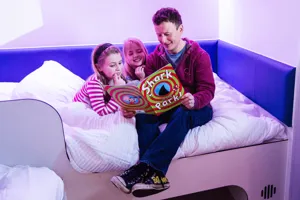 Thorpe Shark Cabins, dad reading a bedtime story to his daughters