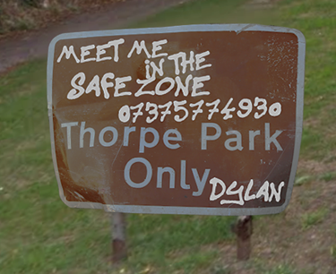 Road sign reading : Meet Me in the safezone 07375774930. Thorpe Park Only. Written by someone called Dylan