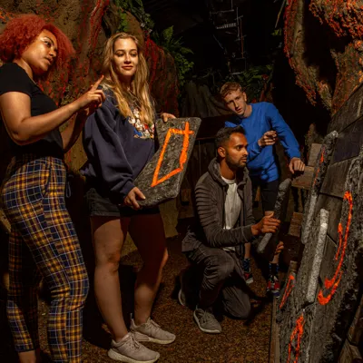 Jungle Escape Puzzle Escape Room, Group solving a puzzle